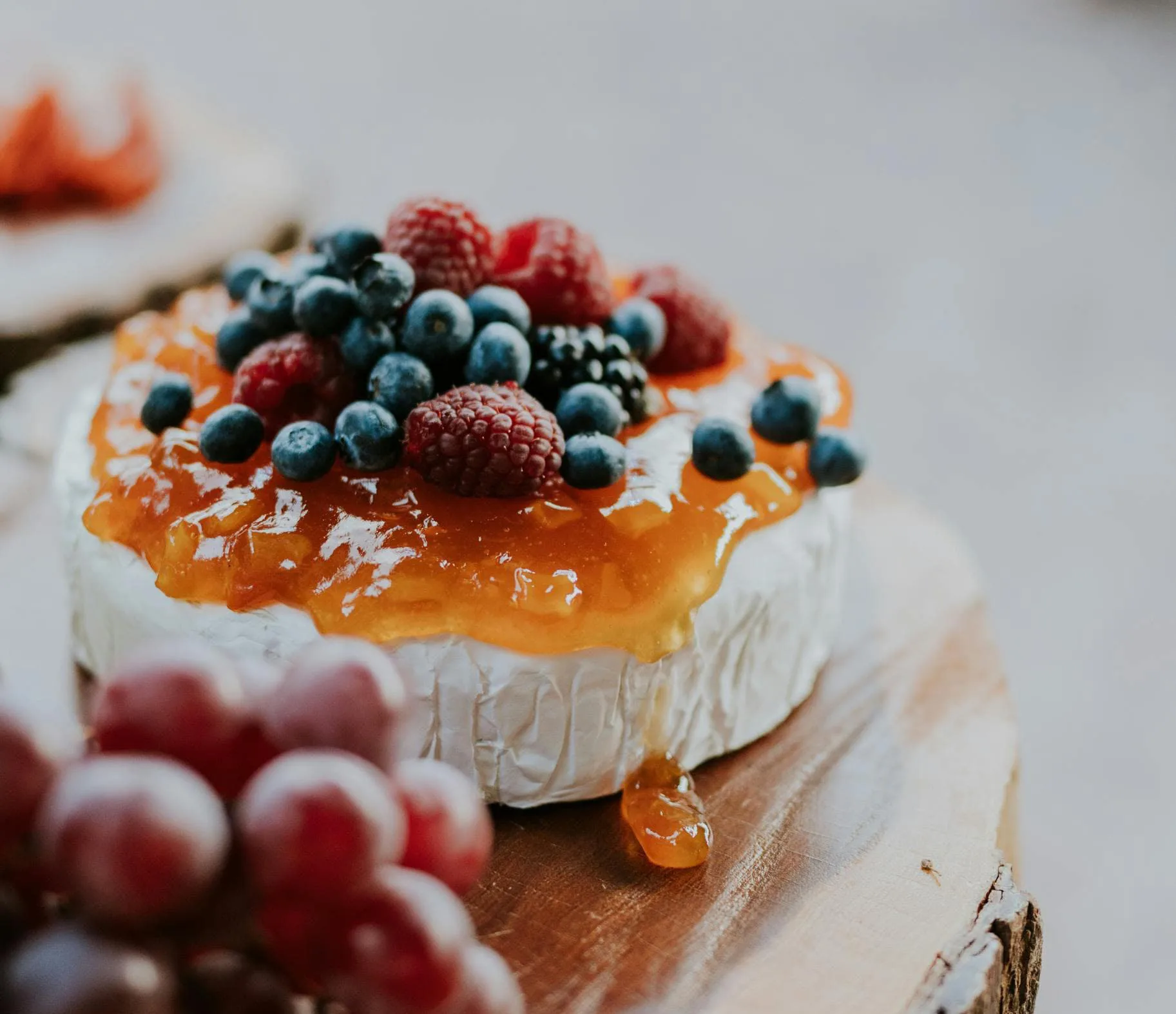 Delicious gourmet cheese topped with fresh berries and apricot jam.