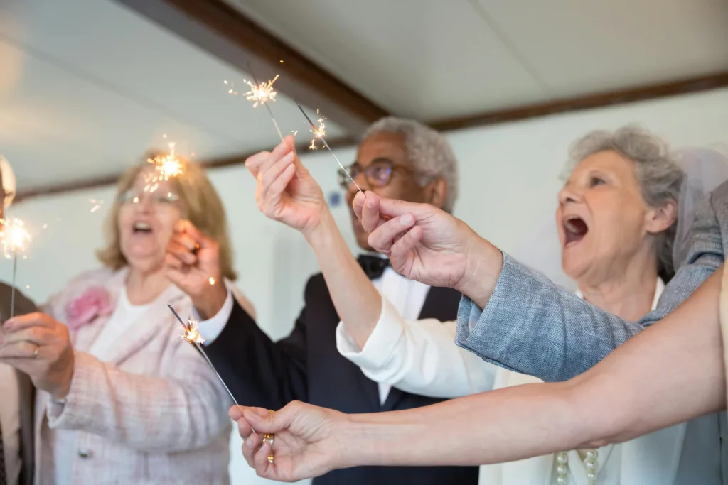 Elderly residents celebrating with sparklers.