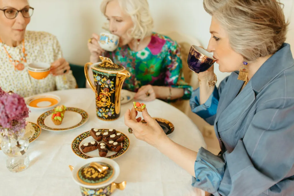 Senior women enjoying a tea party with elegant tableware.